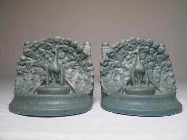 Appraisal: Pair Rookwood pottery peacock bookends blue-green crackle type finish Circa