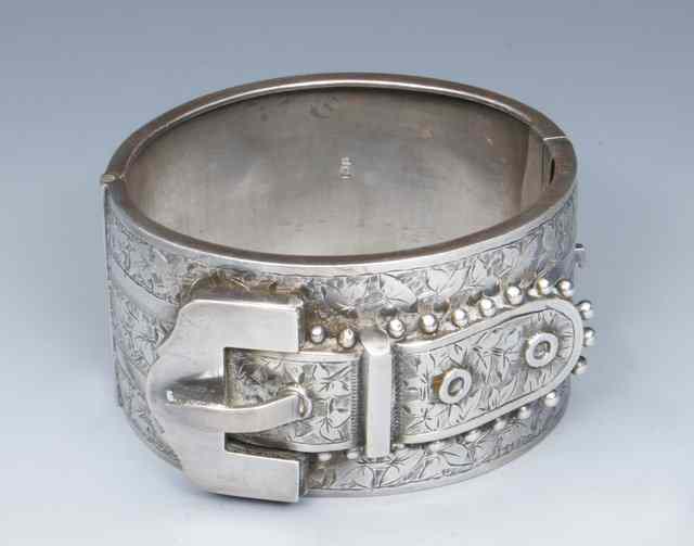 Appraisal: A VICTORIAN SILVER HINGED BANGLE in the form of a