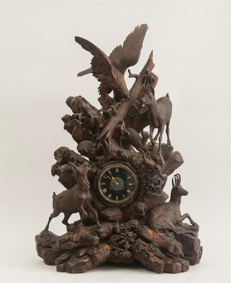 Appraisal: GERMAN BLACK FOREST CARVED WALNUT FIGURAL CLOCK The movement contained