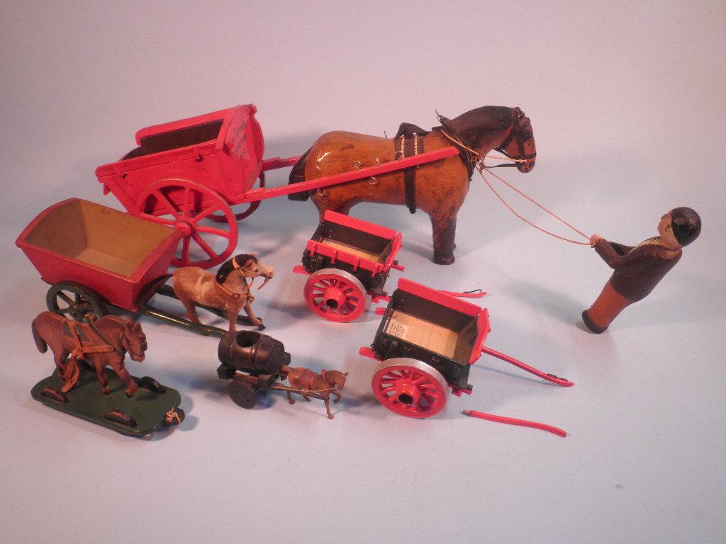 Appraisal: A carved wooden horse and cart the cart bearing words