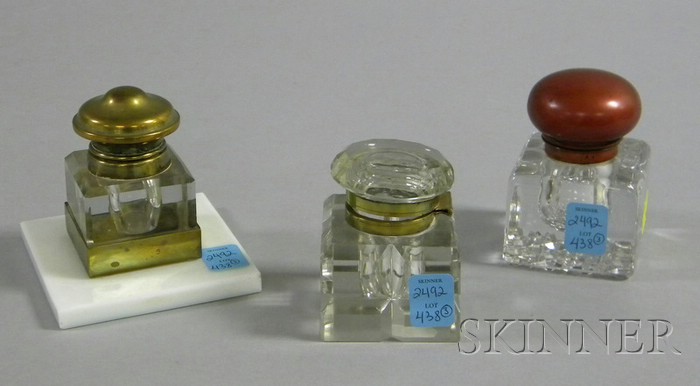 Appraisal: Three Metal-mounted Colorless Glass Inkwells one mounted on a square