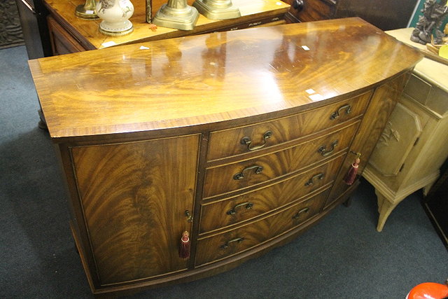 Appraisal: A GEORGIAN STYLE WALNUT AND MAHOGANY BOW FRONTED SIDEBOARD purchased