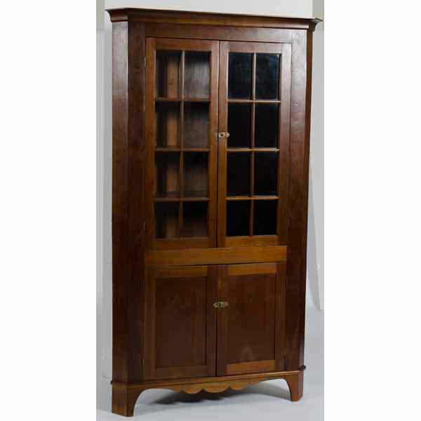 Appraisal: Walnut Corner Cupboard American th century A corner cupboard in