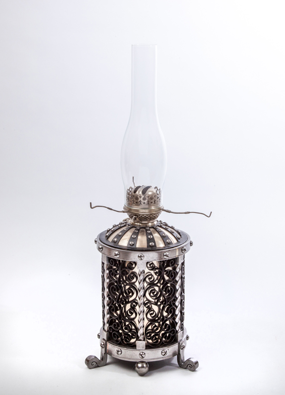 Appraisal: ARTS AND CRAFTS KEROSENE LAMP Polished and painted hand-wrought steel