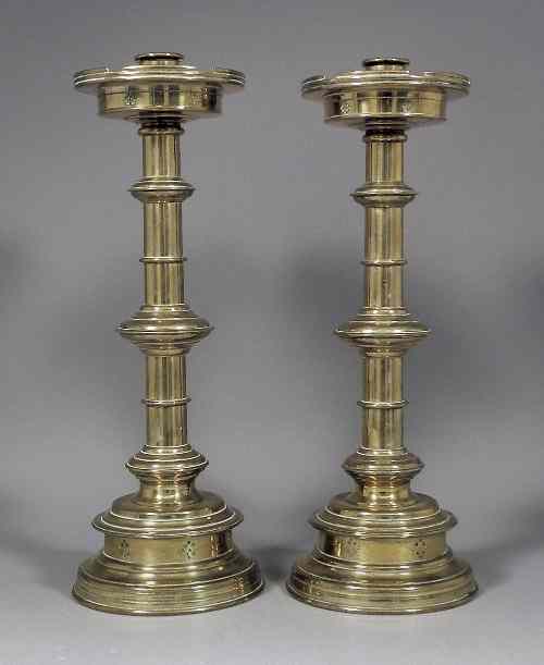 Appraisal: A pair of Victorian brass pillar candlesticks of ''Ecclesiastical'' design