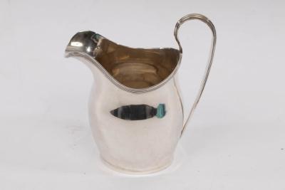 Appraisal: An Edwardian silver cream jug Nathan Hayes Chester with reeded