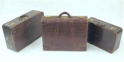 Appraisal: Three brown 'crocodile' pattern leather suitcases early th century Comprising