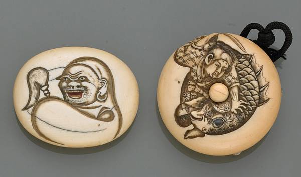 Appraisal: Two ivory manju The first carved with Daruma holding a