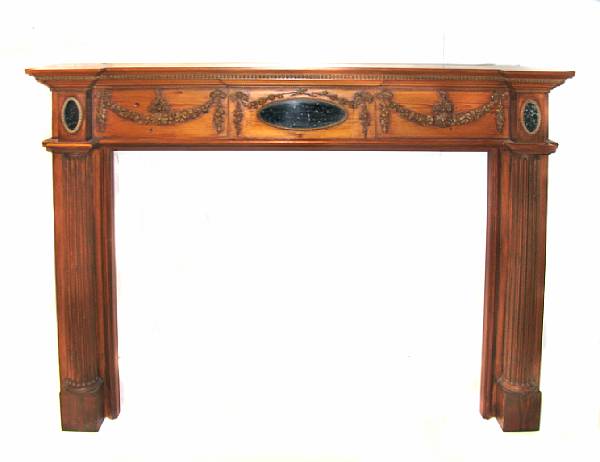 Appraisal: A Neoclassical style carved mixed wood fire surround with overmantel