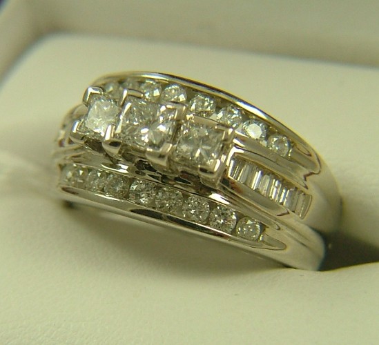 Appraisal: DIAMOND AND EIGHTEEN KARAT WHITE GOLD RING set with princess-cut