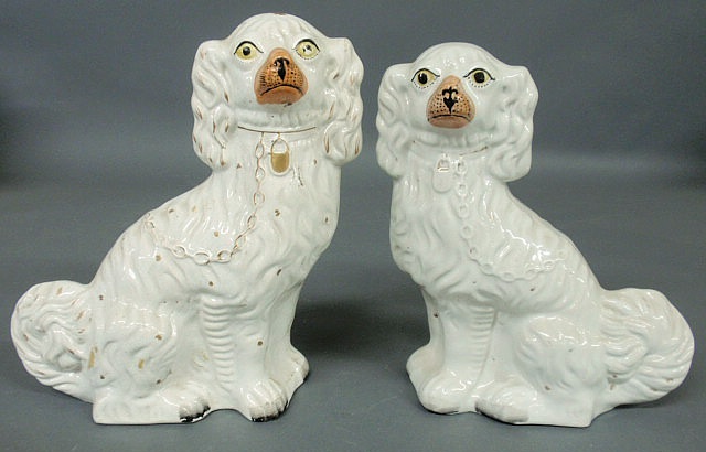 Appraisal: Two similar Staffordshire seated white Spaniels c h h