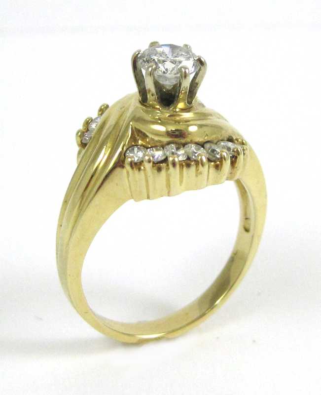 Appraisal: DIAMOND AND FOURTEEN KARAT GOLD RING with round-cut diamonds set