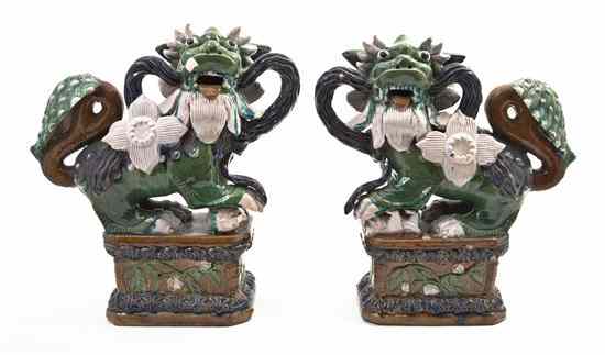 Appraisal: A Pair of Chinese Glazed Fu Dogs depicted in opposing