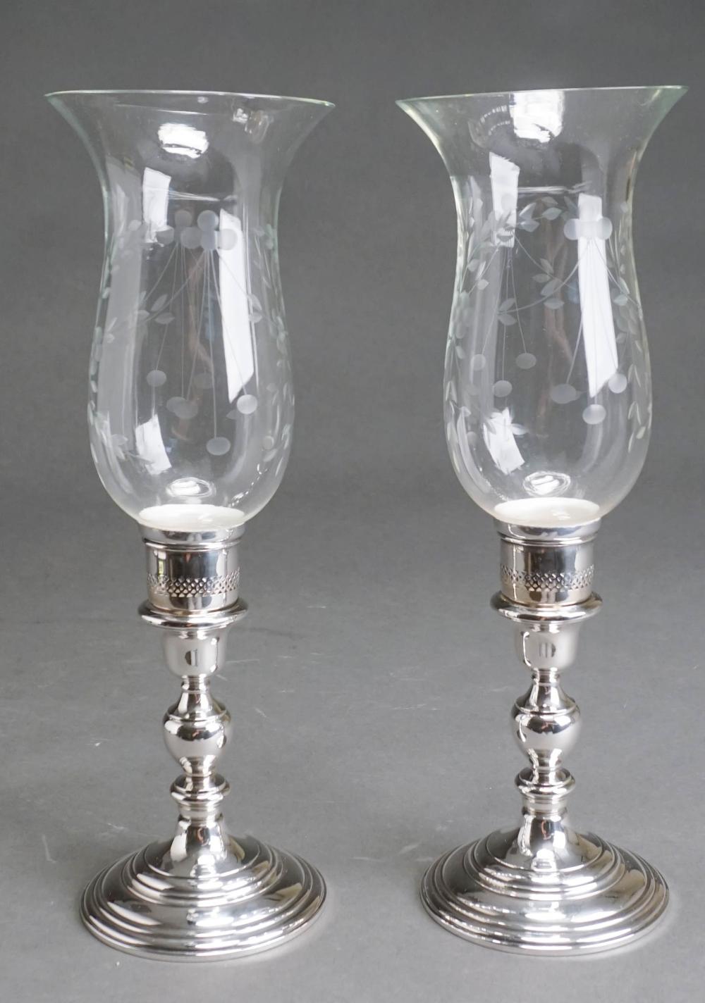 Appraisal: PAIR CARTIER WEIGHTED STERLING SILVER AND HURRICANE GLASS CANDLESTICKS H