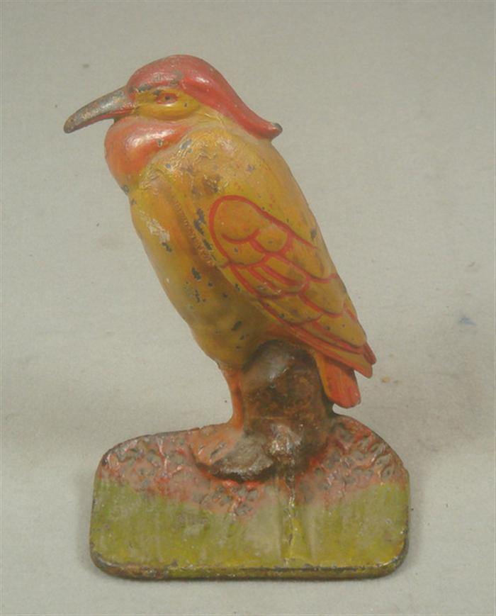 Appraisal: Cast iron doorstop red and yellow bird no stampings felt