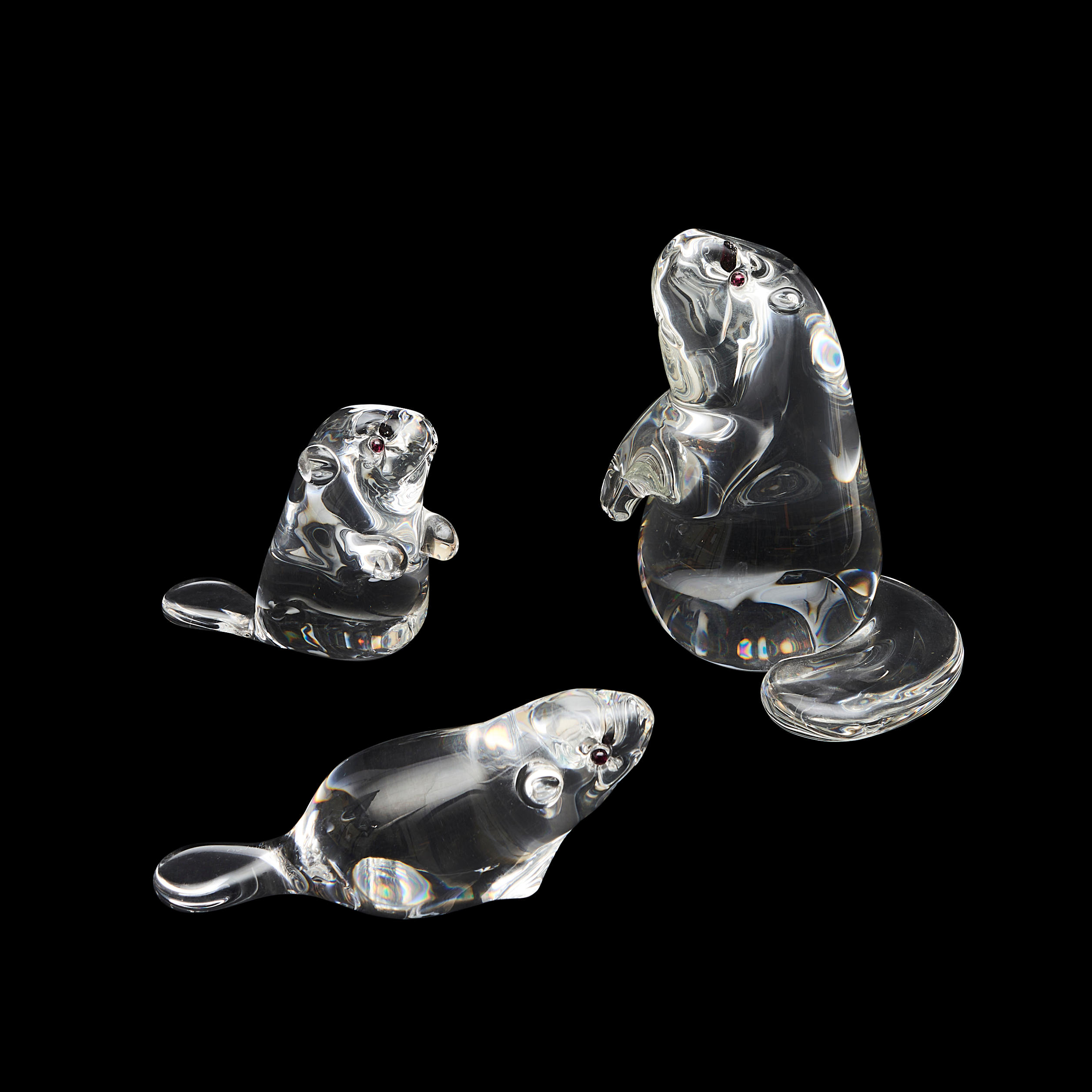 Appraisal: THREE STEUBEN COLORLESS GLASS BEAVERS WITH GARNET-SET EYES all marked