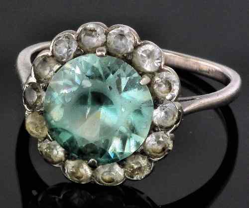 Appraisal: A silvery coloured metal mounted pale zircon and spinel flowerhead