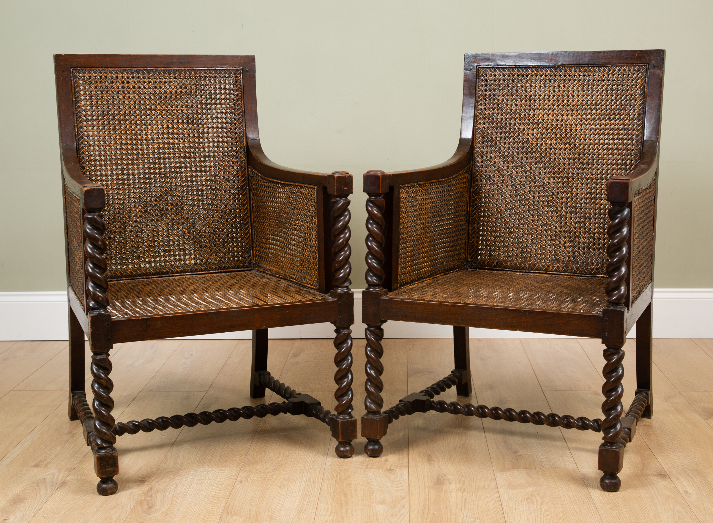 Appraisal: A pair of early th century oak framed Bergere armchairs