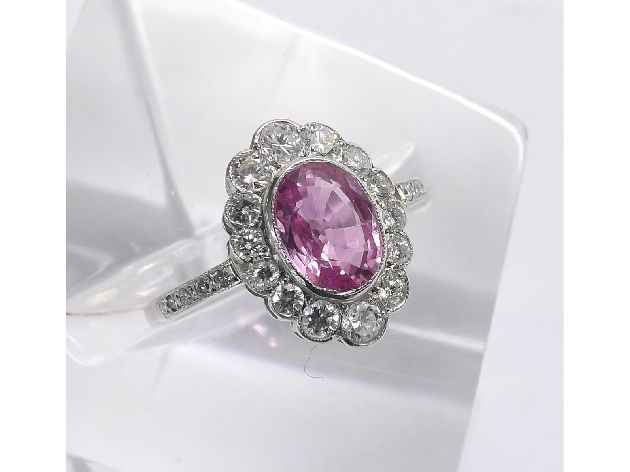 Appraisal: Platinum pink sapphire and diamond oval cluster ring the central