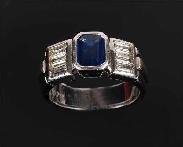 Appraisal: A sapphire and diamond band ring the central square cut