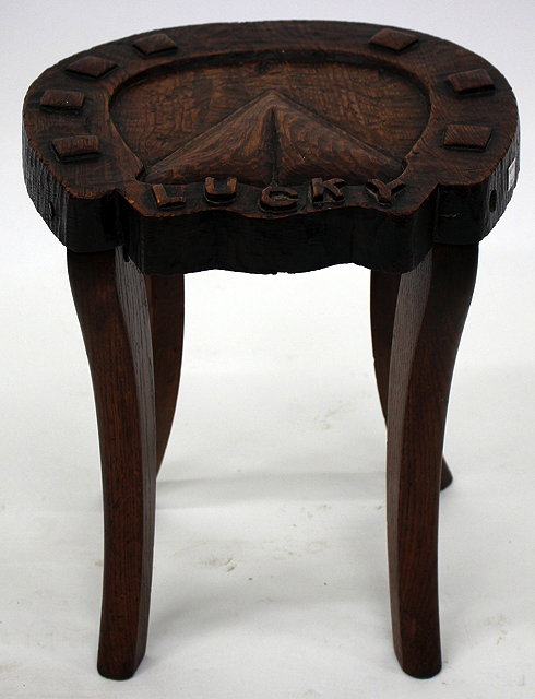 Appraisal: A CARVED OAK STOOL in the form of a lucky