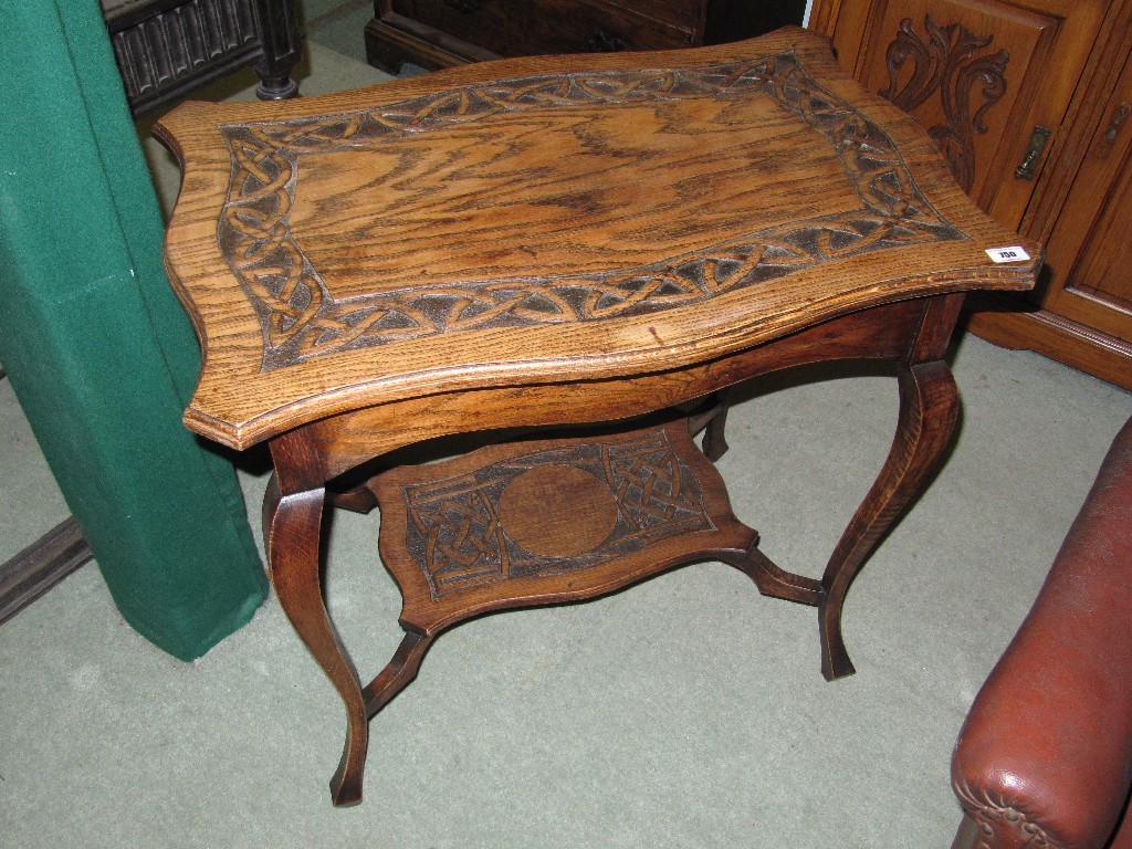 Appraisal: Oak two tier occasional table with Celtic design to the