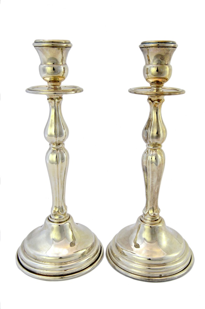 Appraisal: A pair of European table candlesticks on circular bases detailed