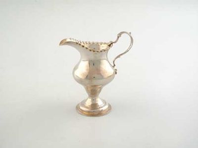 Appraisal: A George III baluster cream jug with a punched beaded