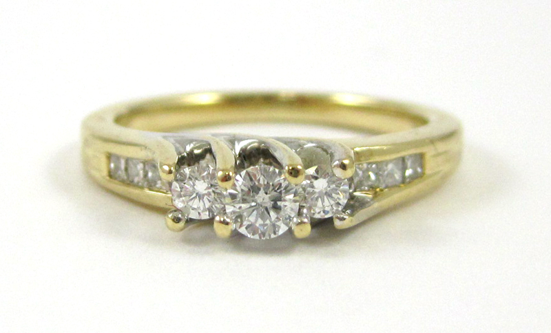 Appraisal: DIAMOND AND FOURTEEN KARAT GOLD RING with princess-cut diamonds set