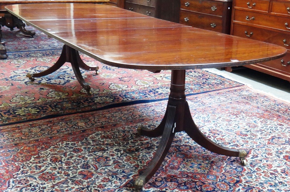 Appraisal: A Regency style mahogany twin pedestal extending 'D' end dining