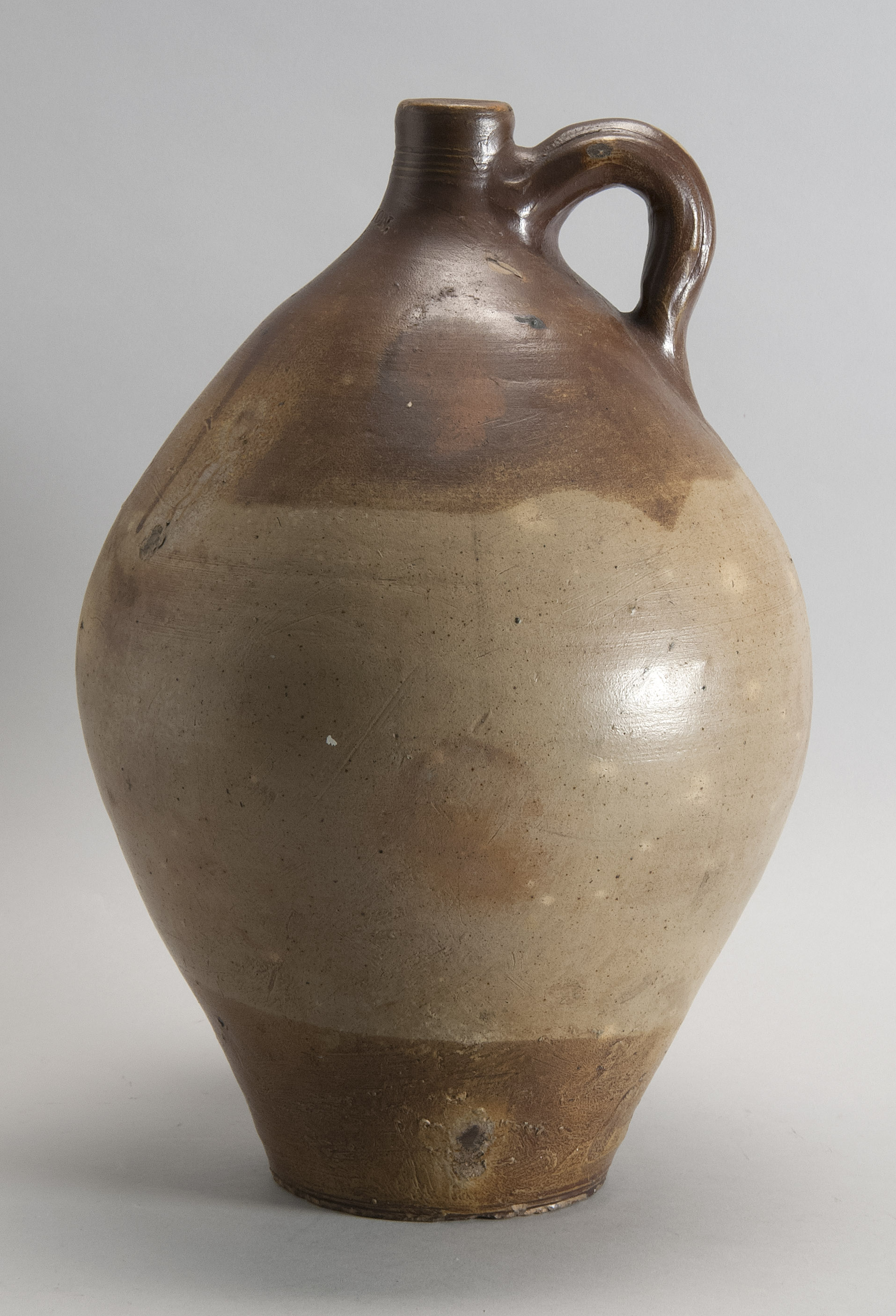 Appraisal: STONEWARE OVOID JUG American Circa In brown and cream glaze