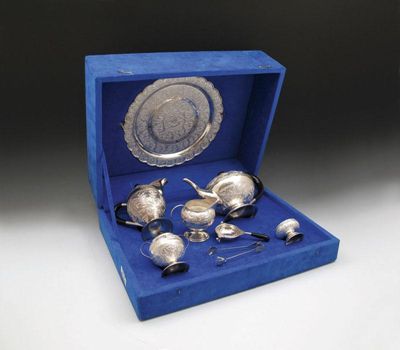 Appraisal: A South-East Asian presentation metalware tea service comprising a circular