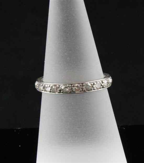 Appraisal: A platinum and diamond eternity ring with twenty stones Size