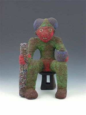 Appraisal: A Bamileke beadwork figure Cameroon seated on a stool holding