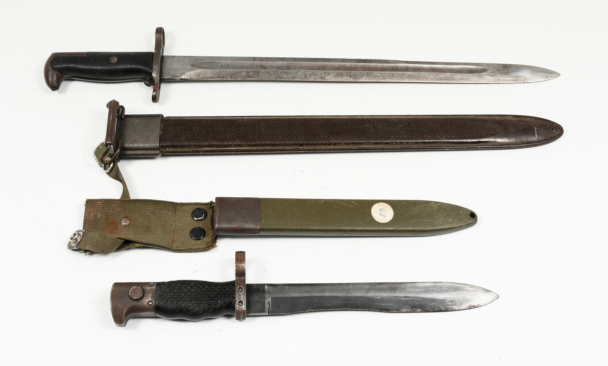 Appraisal: TWO U S MILITARY BAYONETS German-made bayonet indecipherable markings camo-green