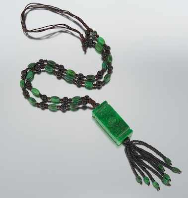 Appraisal: A Carved Jadeite and Onyx Tassel Necklace The necklace is