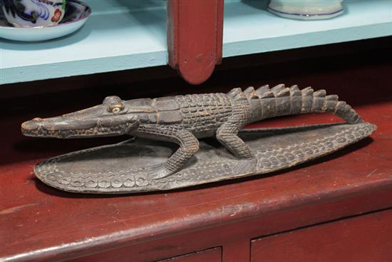 Appraisal: CARVED CROCODILE FETISH Probably New Guinea Having inset cowrie shell