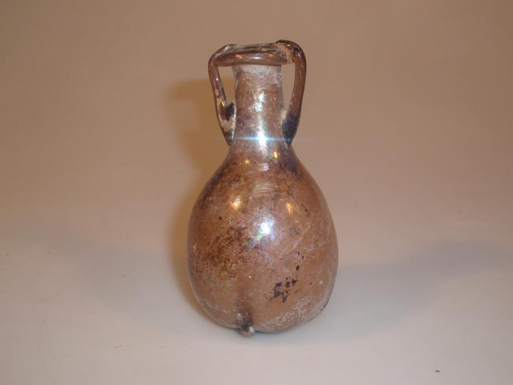 Appraisal: A Roman light purple glass amphoriskos the triangular infolded tubular