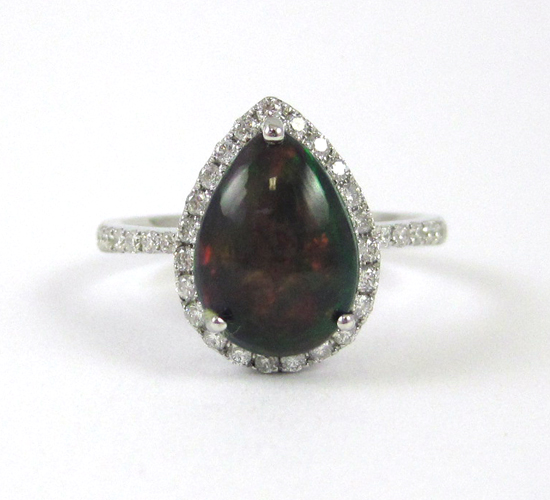 Appraisal: BLACK OPAL AND FOURTEEN KARAT WHITE GOLD RING with round-cut