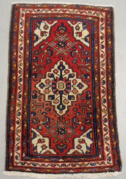 Appraisal: - Persian oriental mat with a red field and center