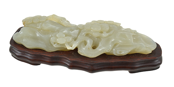 Appraisal: A CHINESE JADE CARVING depicting pine trees growing from rock