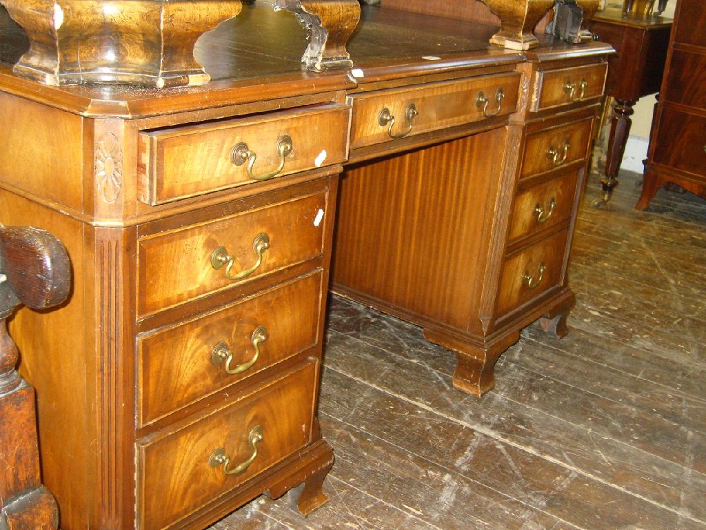 Appraisal: A reproduction Georgian style mahogany kneehole partners desk fitted with