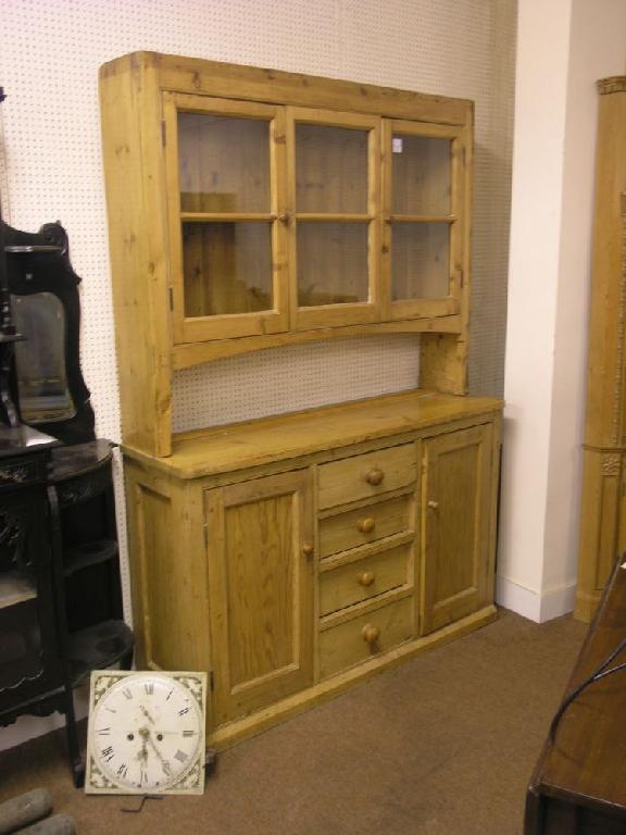 Appraisal: A late Victorian stripped pine kitchen dresser with glazed plate