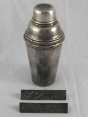 Appraisal: A silver plated cocktail shaker incorporating a fruit sqeezer James