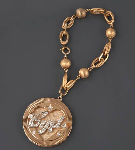 Appraisal: A k gold charm bracelet with one k gold and