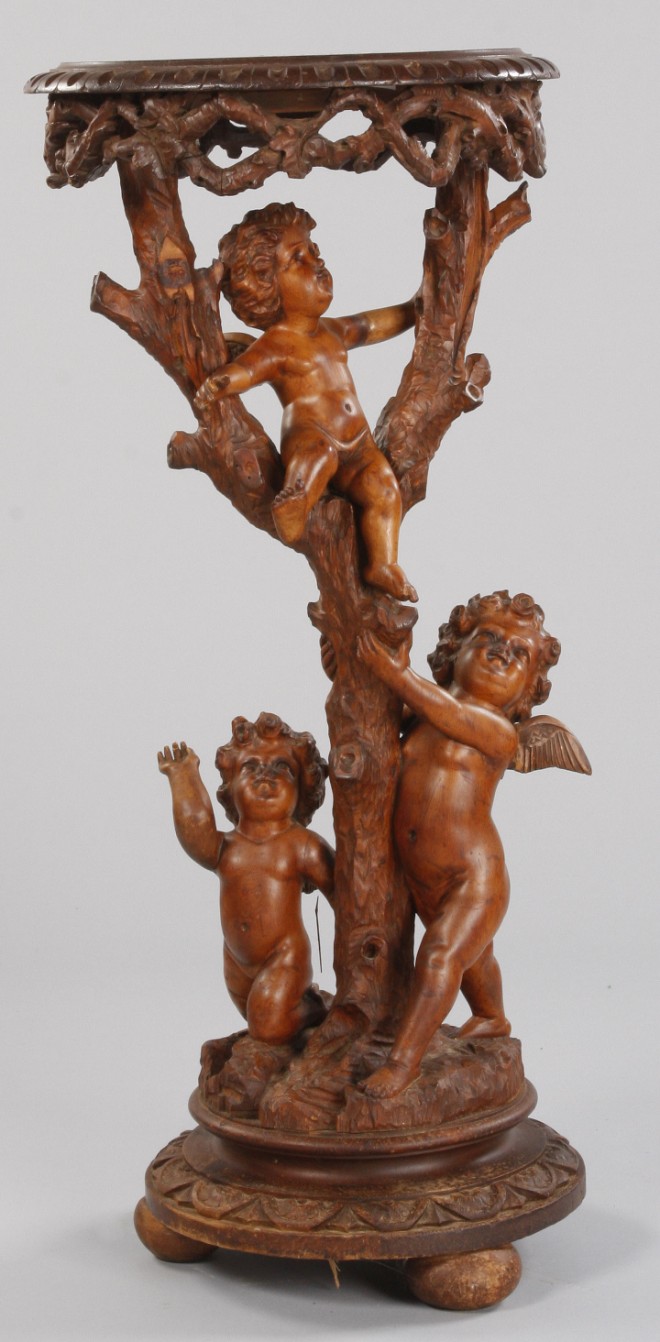 Appraisal: Pine tree form pedestal with three putti one seated in