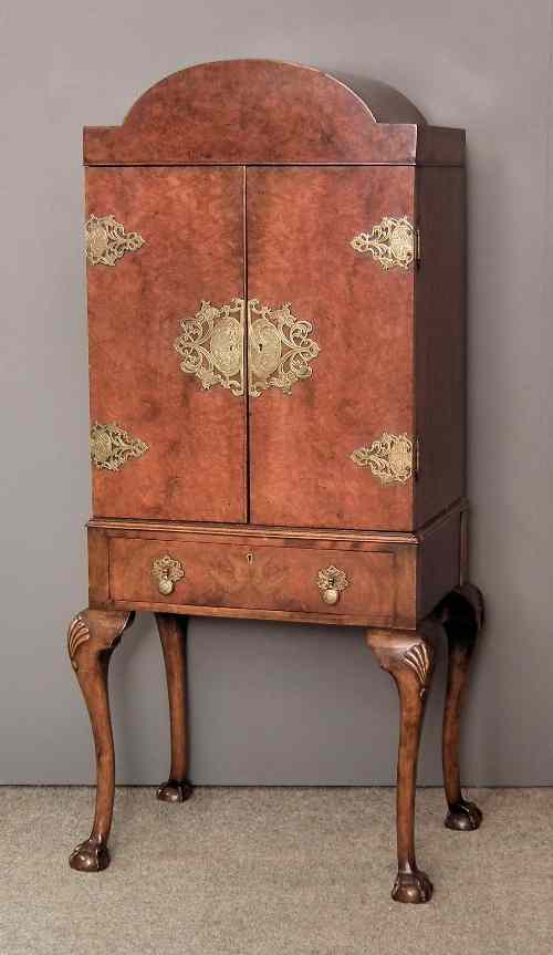 Appraisal: A s figured walnut and brass mounted cocktail cabinet of