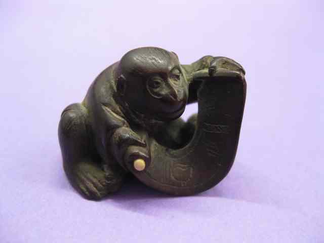 Appraisal: Carved Wooden Netsuke of a Monkeywith scroll signed '' x