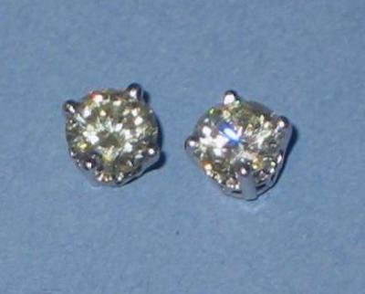 Appraisal: A PAIR OF DIAMOND STUD EARRINGS the brilliant cut diamonds