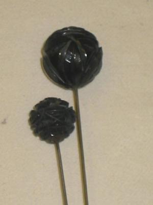 Appraisal: TWO VICTORIAN JET HAT PINS the ball ends carved as